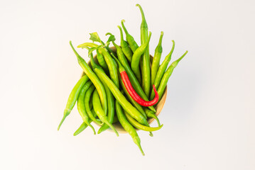 Bowl of vibrant green and red chilies, perfect for spicy cooking.
