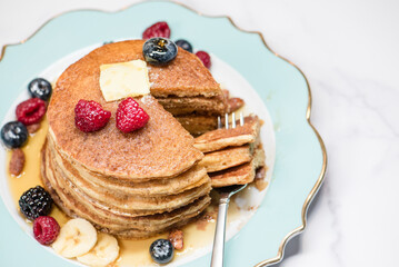 Pancakes with a portion cut through with a fork
