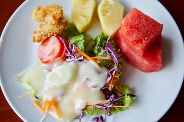 Healthy salad with dressing for salad on plate