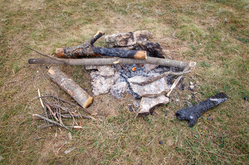 A pile of wood and ash on the ground