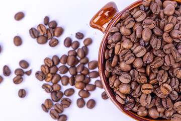 Top View of Coffee Beans in a Brown Bowl with Surrounding Beans