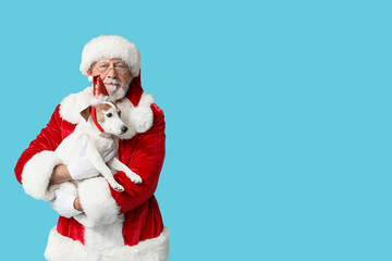 Santa Claus with cute Jack Russell Terrier dog on blue background