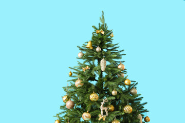 Christmas tree with beautiful decorations on color background, closeup