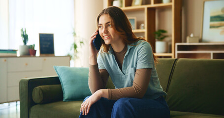 Obraz premium House, phone call and woman on sofa, smile and relax with discussion, talking and mobile user. Apartment, happy person and girl with smartphone, connection and chatting to contact and communication