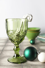 Glass with decorated Christmas table setting on white background