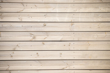 A wooden background with a few small holes in it