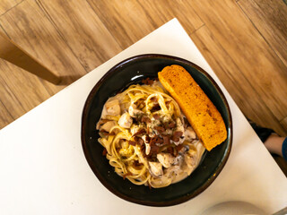 beef fetuccini carbonara with mushroom sauce on wooden table