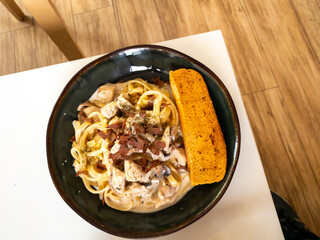 beef fetuccini carbonara with mushroom sauce on wooden table