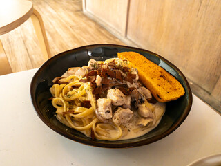 beef fetuccini carbonara with mushroom sauce on wooden table