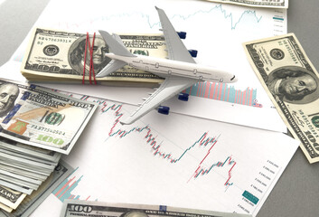 Airplane model on financial reports background 