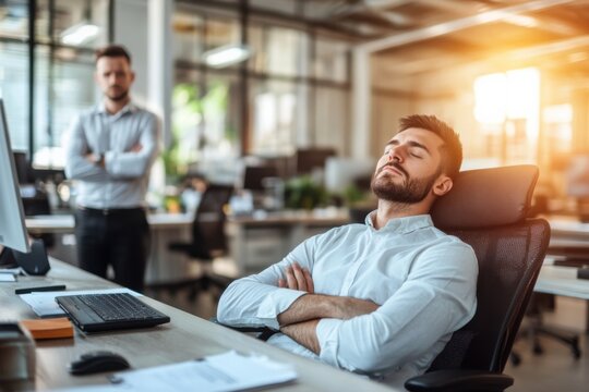 Lazy office worker asleep at his desk, boss standing behind with arms crossed