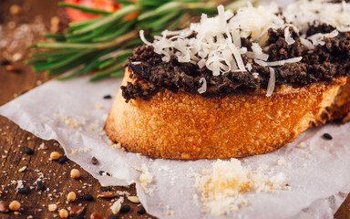 Delicious bruschetta with black truffle spread and parmesan cheese