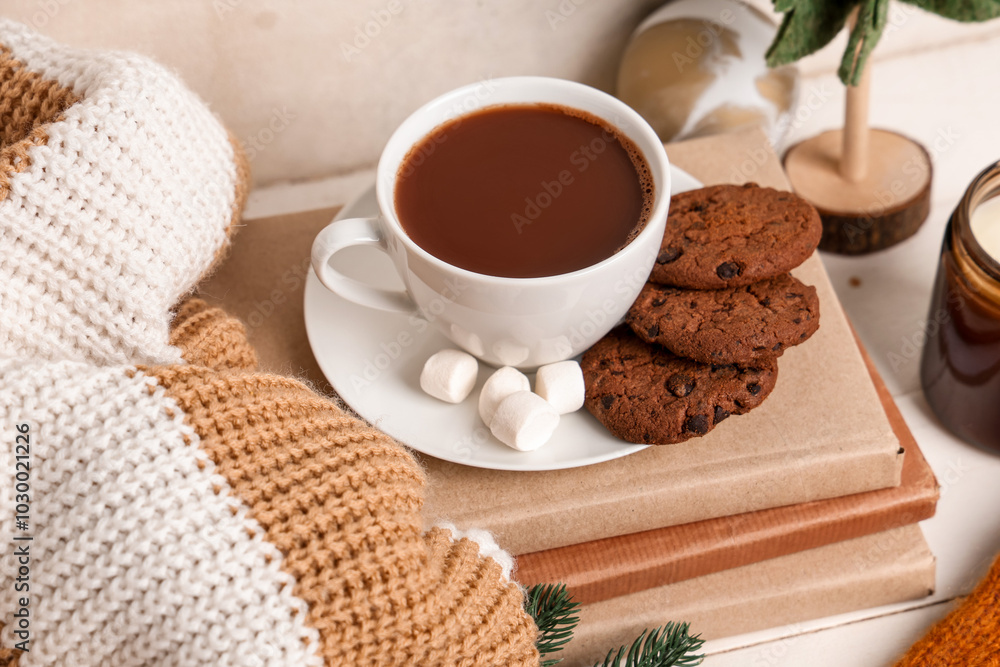 Sticker beautiful composition with books, warm clothes, winter decor and cup of cacao on white wooden backgr