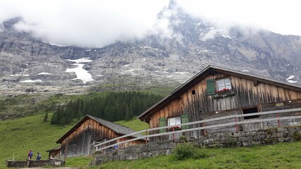 Panoramic view of Alps in Switzerland. Rock, high mountains in South Europe. Wooden hut. 
