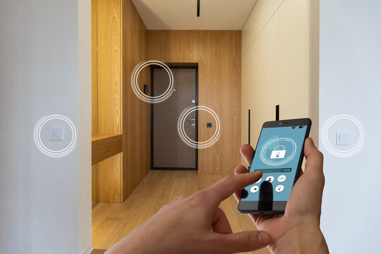 smart house, home automation, device with app icons. woman uses his smartphone with smarthome security app to unlock the door of his house.