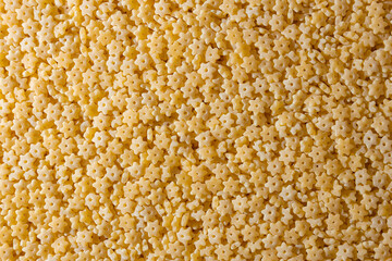 Uncooked Stelline Pasta: A Culinary Canvas of Stelline Macaroni, Creating a Lively and Textured Background for Gourmet Cooking. Dry Pasta. Raw Macaroni - Top View, Flat Lay