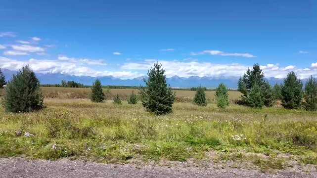 View from the side window of the car to the Tunka mountains. Auto tour of the Tunka Valley, Buryatia