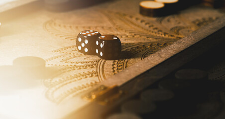 Wooden backgammon board with dice and pieces close up 