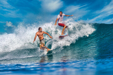 Two male surfers on a blue wave at sunny day