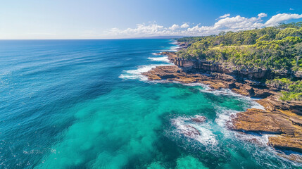 The ocean is blue and the shore is rocky