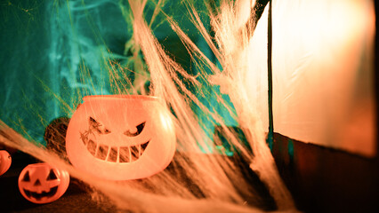 Spiderweb Blowing In The Wind Near Halloween Pumpkins Near A Window
