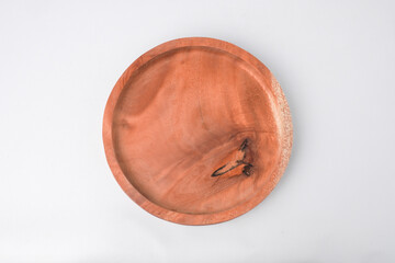 Close-up photo of Wooden plate isolated on white background. High angle, Flat Lay Setup.