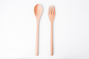 Close-up photo of wooden table spoon and fork isolated on white background. High angle, Flat Lay, Bundling Setup.