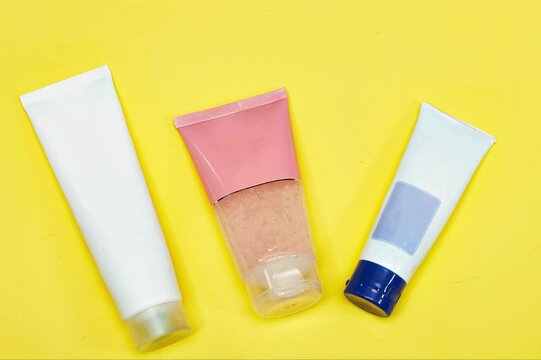 Beauty cosmetics tube; branding mock up isolated on yellow background. Package for hand cream or scrub. Beauty cosmetics tube, branding mock up
