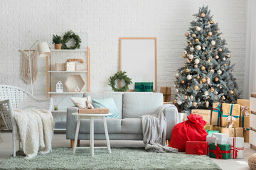 Interior of festive living room with grey sofa, Christmas tree and Santa Claus bag