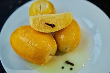 Pickled lemons with cloves. Aromatic seasoning for meat