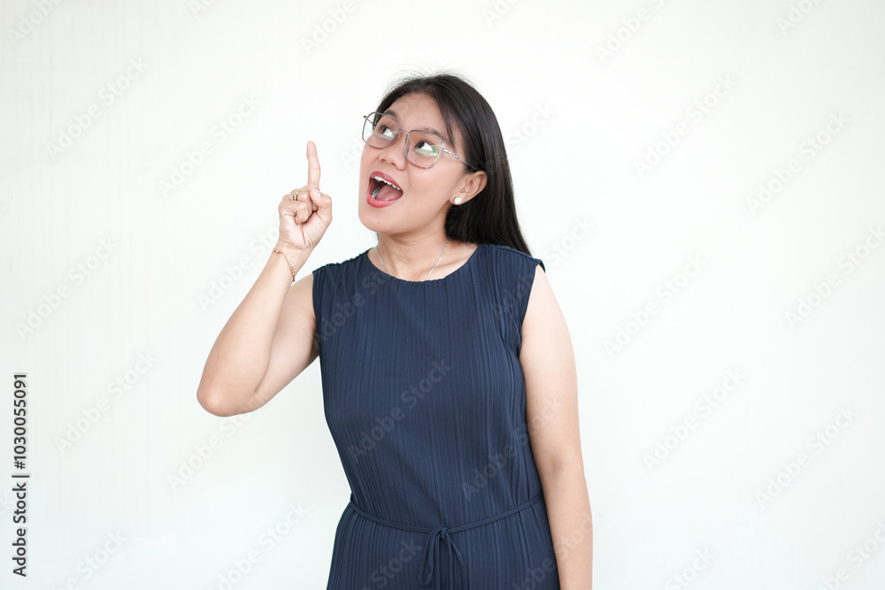 Wall mural beautiful asian woman pointing up got an idea isolated on white background