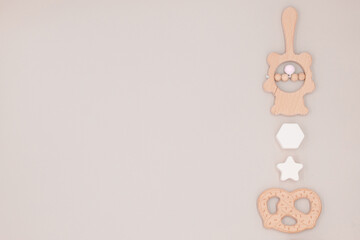 Cute background in pastel colors with copy space, newborn baby toy, teether and kids accessories made of natural material