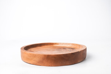 Close-up photo of Circular Wooden plate isolated on white background. Shot on Eye-level angle setup.