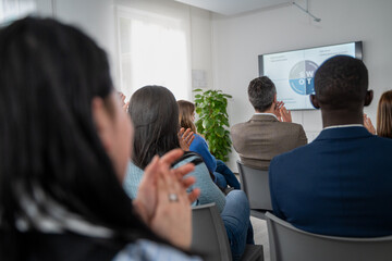 Diverse business team meeting presentation conference room professional development training seminar workplace diversity inclusion