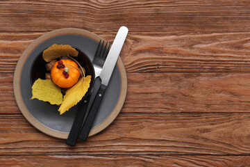 Stylish table setting with autumn decor on wooden background