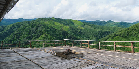 Naklejka premium Landscape image of mountain view from wooden balcony with bonfire