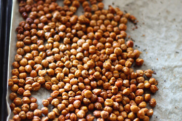 Sheet pan with homemade roasted chickpeas. Selective focus.