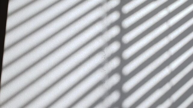 Woman Hand Pulling Sticky Notes With Text Thank You From The Wall Under Stripes Of Shadow