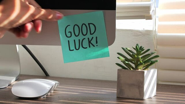 Woman Hand Putting Sticky Notes With Text Good Luck On Computer At Office