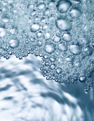 Bubbling water texture, flow thermal water as abstract background macro photo, spa and wellness theme, gentle ripples and gurgling on white blue aquatic surface, sea monochrome color gradient