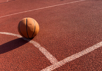 Basketball ball in the outdoors court sunny day