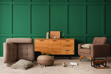 Interior of messy living room with overturned brown armchair, wooden cabinet and fallen decorations...