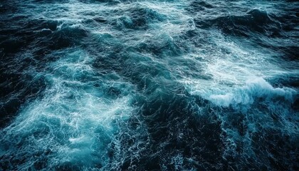 A large body water with choppy waves, viewed from above.
