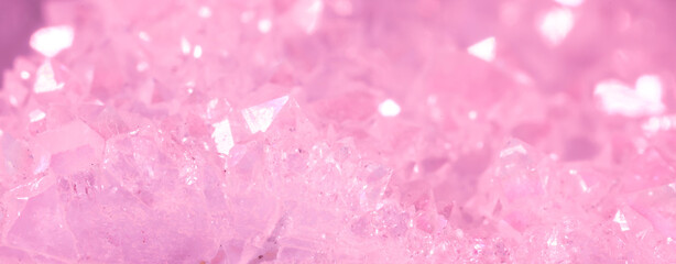 Amethyst pink crystals. Gems. Mineral crystals in the natural environment. Texture of precious and semiprecious stones. Seamless background with copy space colored shiny surface of precious stones.