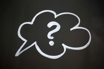 top view of of white question mark on white speech bubble on a black background.