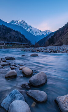 Mountain River in Pangi Valley at Blue Hour with Clear Sky and the Rocky Mountains