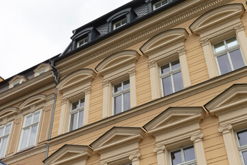 A large and impressive building that features a significant number of windows, as well as several elegant columns adorning its structure