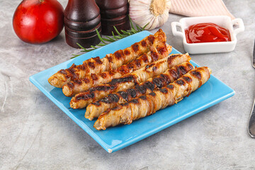 Grilled meat sausages wrapped bacon