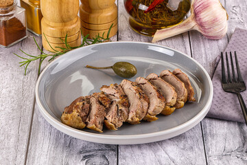 Roasted duck breast slices in the plate