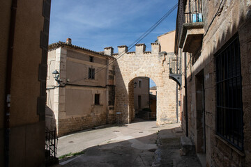 Vista de la Iglesia de Pampliega, España y el arco de su muralla